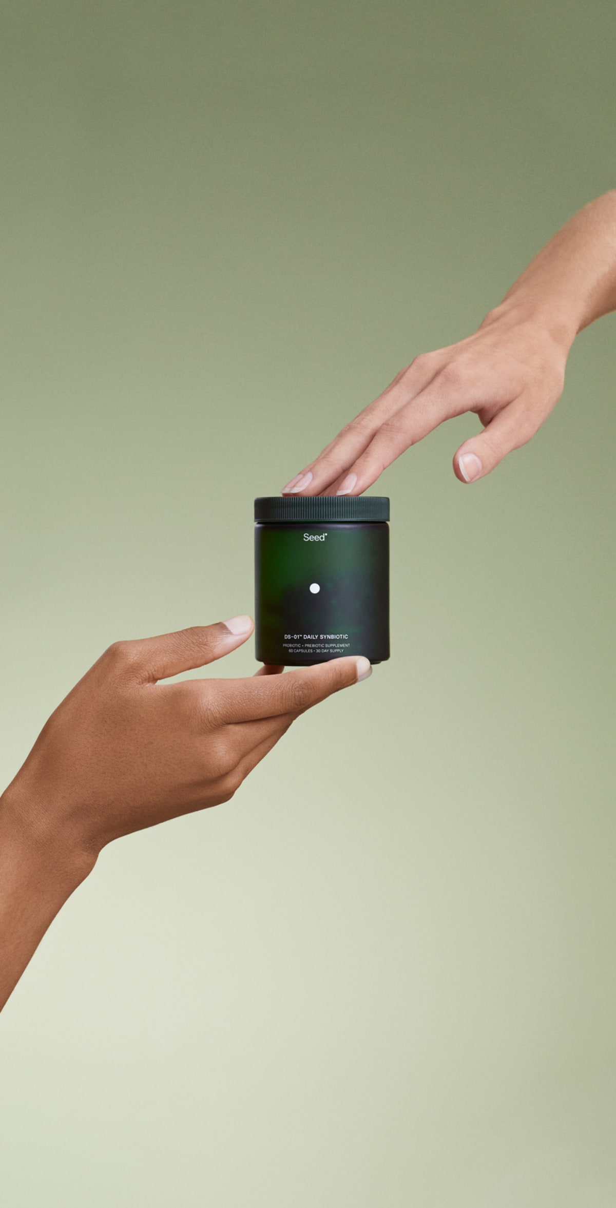 Hands holding the DS-01® daily synbiotic capsules