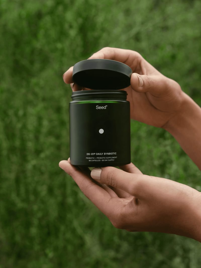 Hand opening a DS-01® jar outdoors
