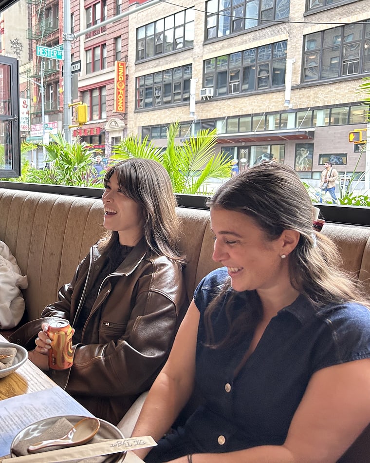 Two Seed team members laughing together at a restaurant