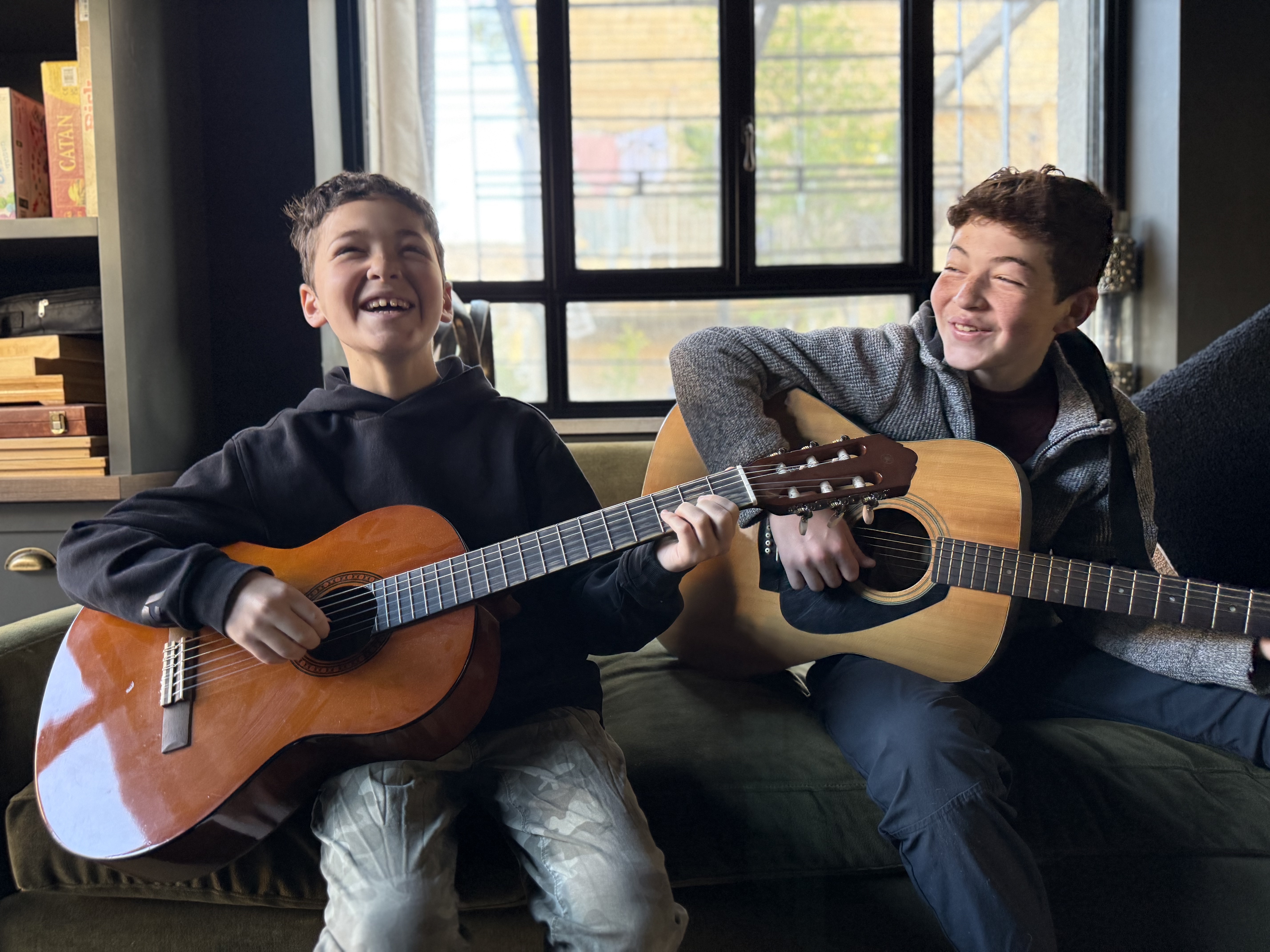 Brothers playing guitars together