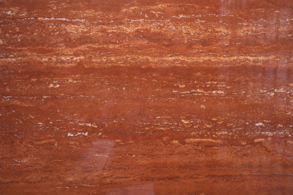 Red Travertine sintered stone — warm russet tones with linear movement