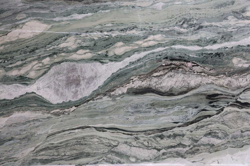 Victoria Green marble — rich green ground with gold-accented veining