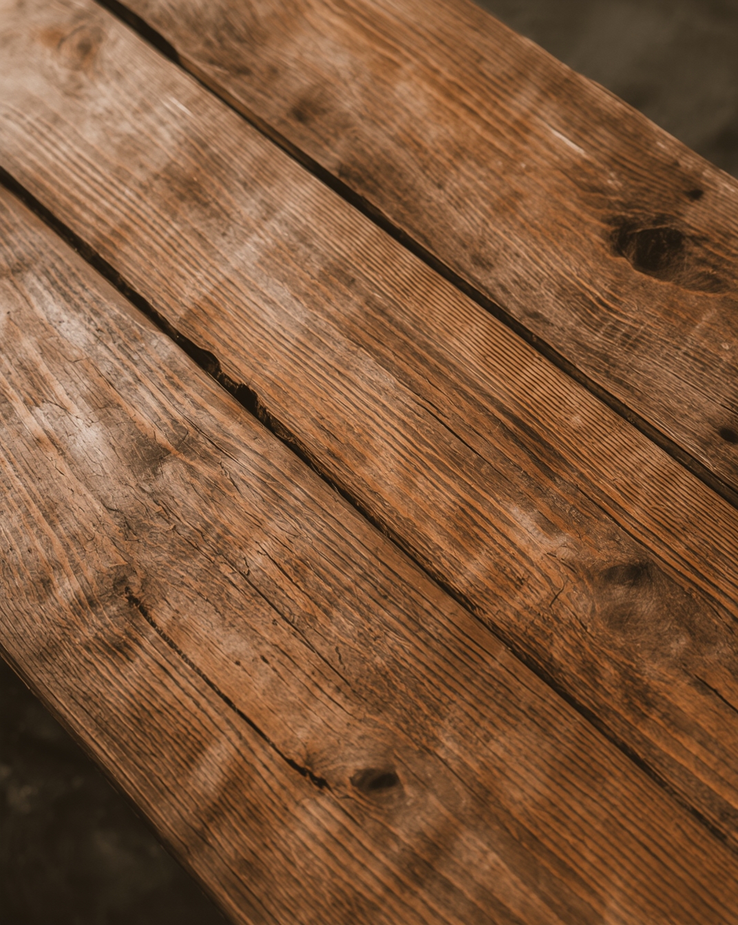 Close-up of aged teak wood surface showing natural patina and wood grain