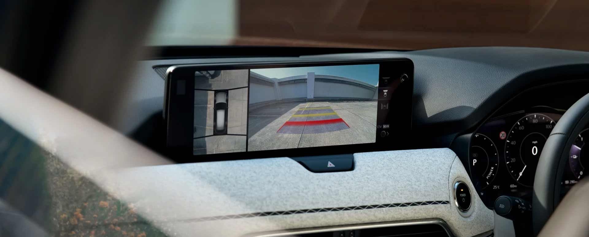Close-up of the Mazda CX-80 7-seat hybrid SUV's touchscreen displaying the rear view camera
