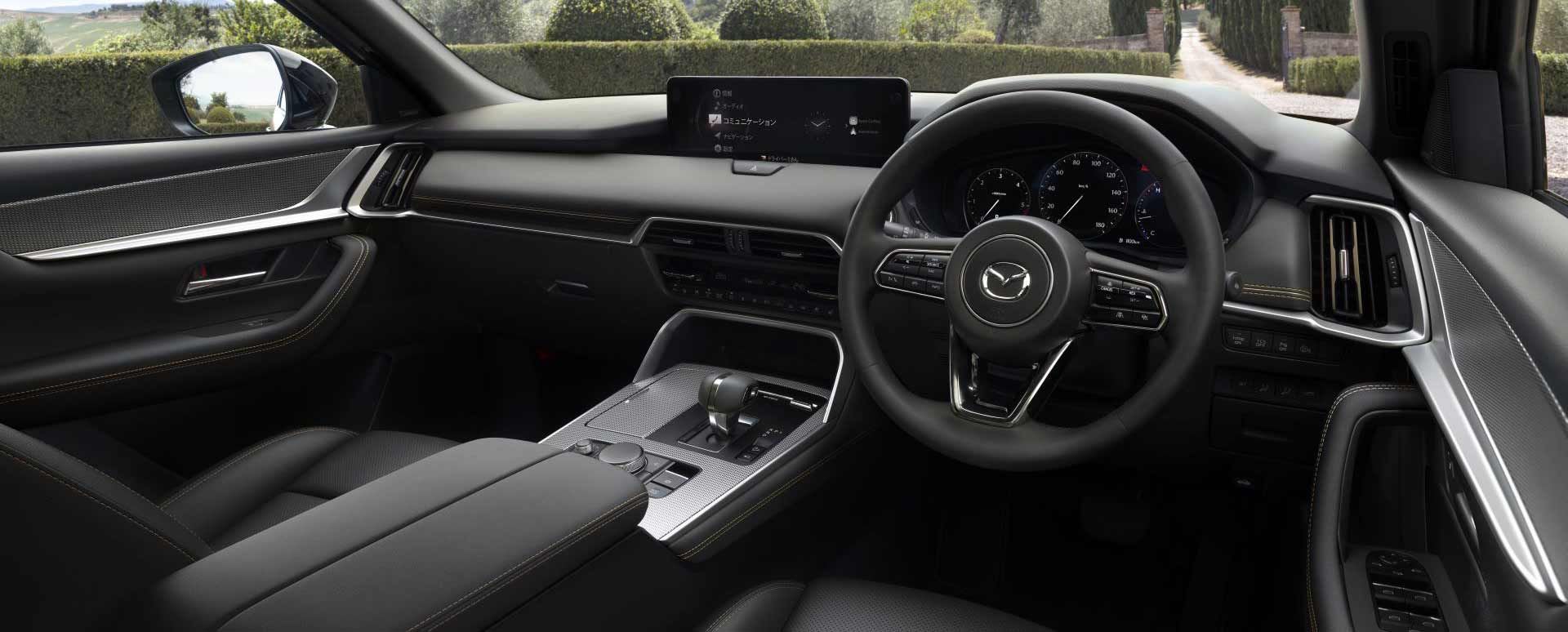 Interior view of the steering wheel and dashboard of a Mazda CX-80 7-seat hybrid SUV 