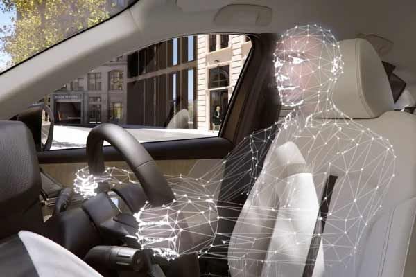 Interior of a Mazda CX-80 7-seat hybrid SUV with a tech line-drawing of a person behind the wheel