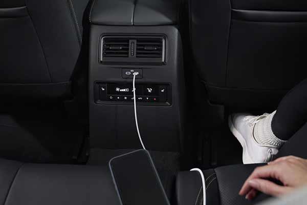 Smart phone plugged into the dashboard of a Mazda CX-80 7-seat hybrid SUV