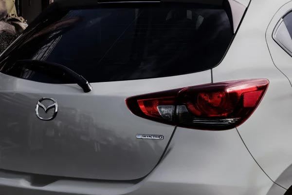 Close-up of the hatch of a Snowflake White Mazda2 hatch