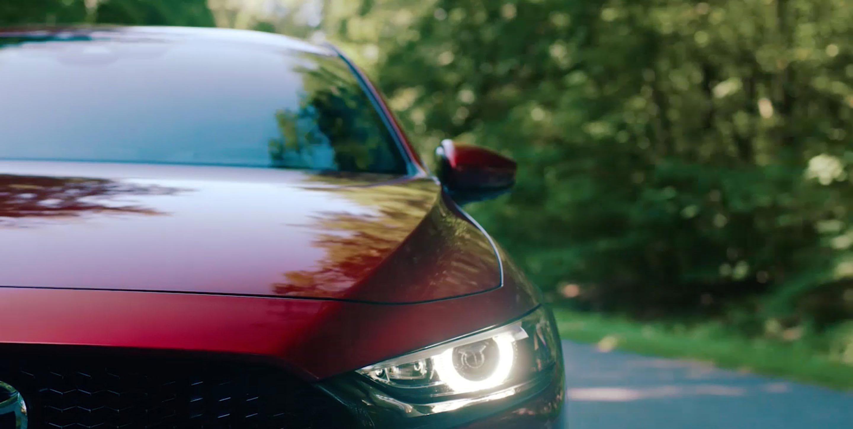 Close-up of the front end of a Soul Red Mazda car