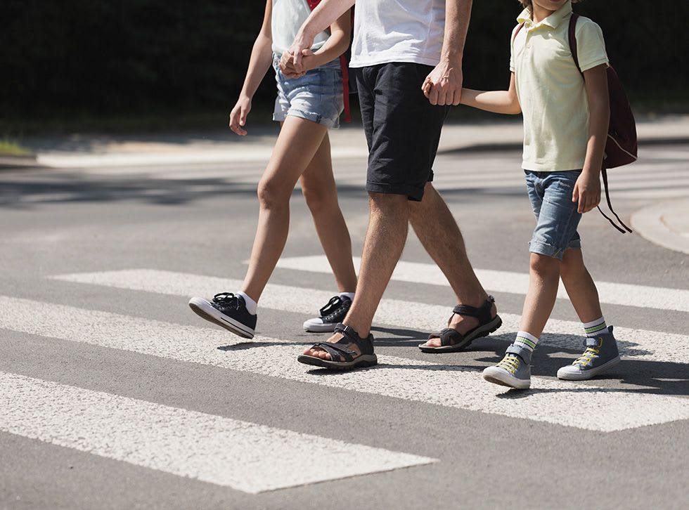 Mazda safety family crossing a pedestrian crossing