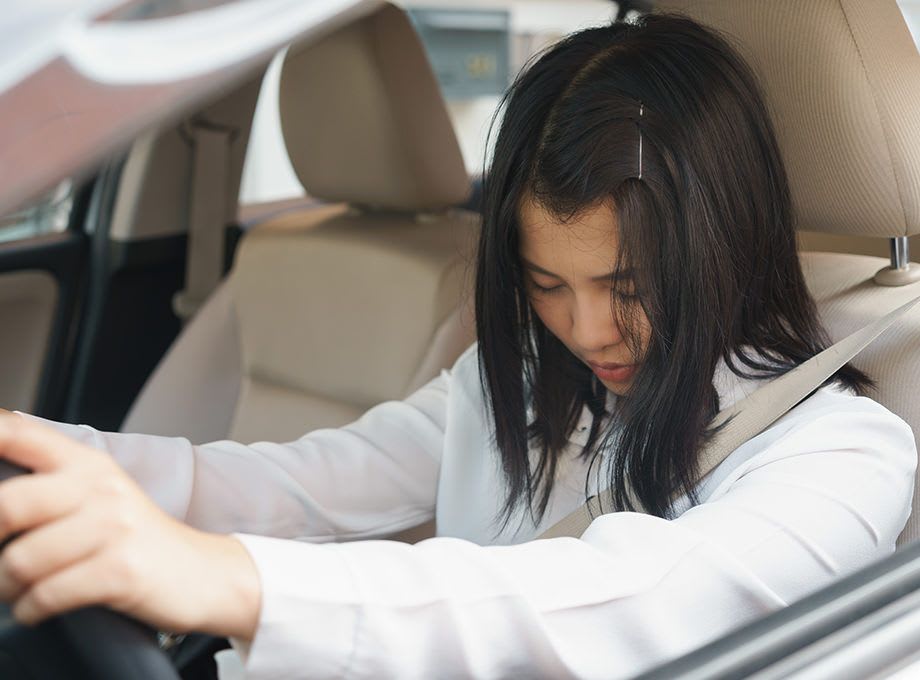 Woman at the wheel of her Mazda car