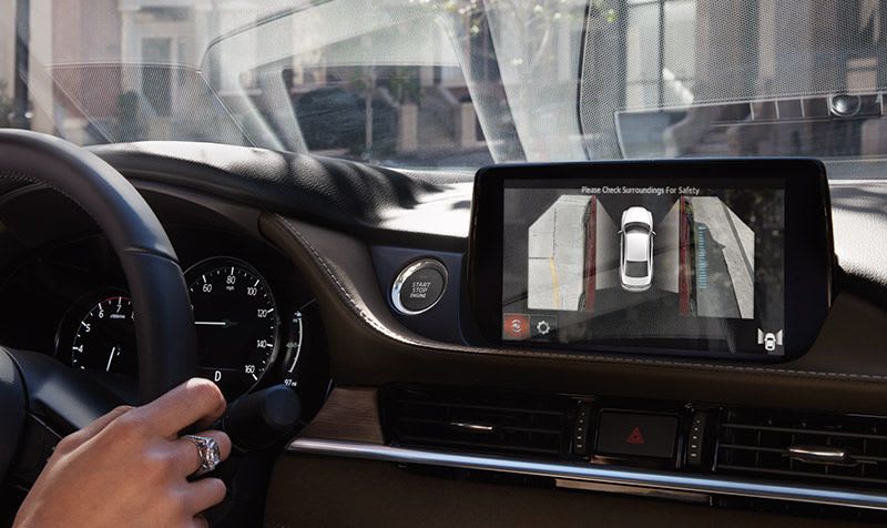 Close-up of a Mazda touchscreen displaying the 360° camera view