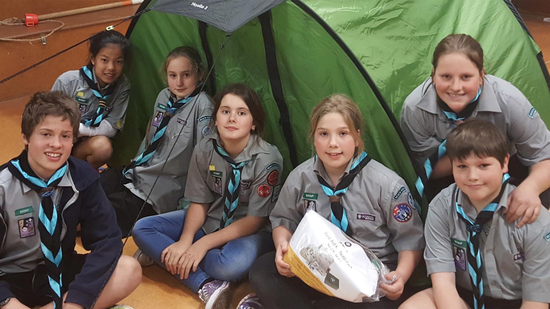 Members of a scout group in front of a tent; the group was a Mazda Foundation grant recipient