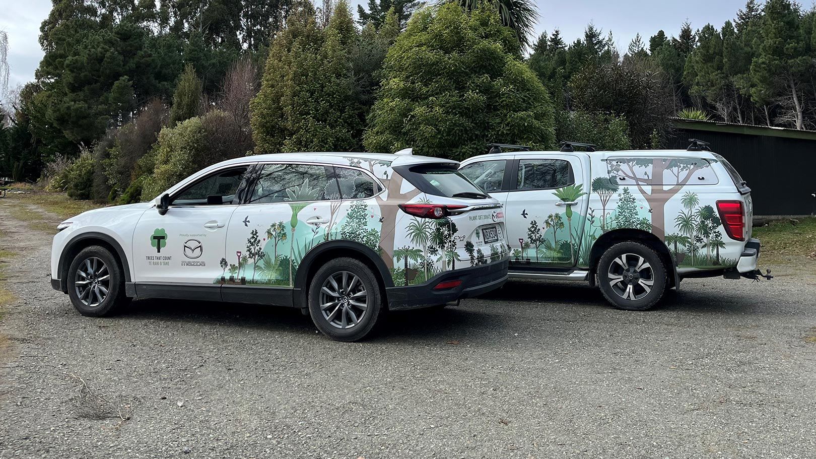 Two Mazda SUVs with decals supporting our partnership with Trees That Count