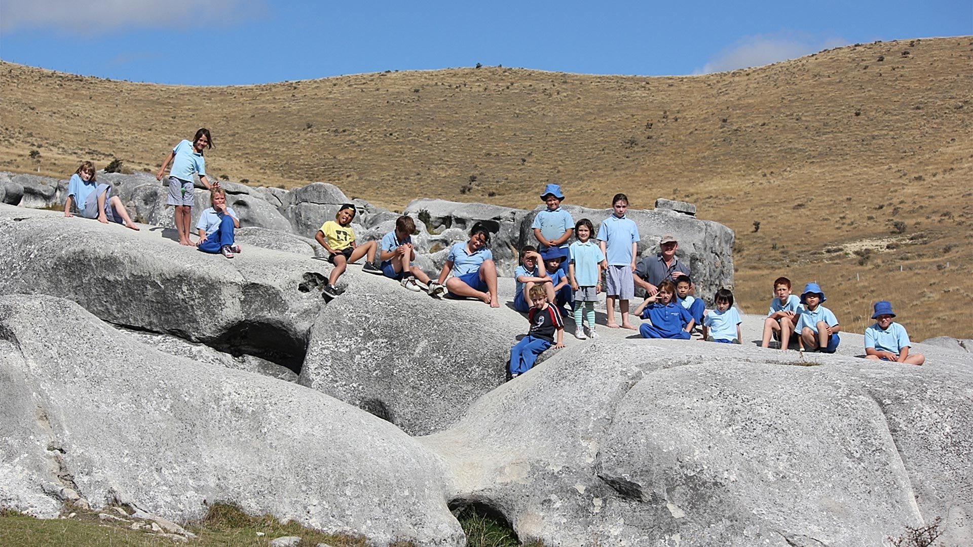 Students and teachers gathering on a rocky landscape - Mazda Foundation 2022 grant recipients