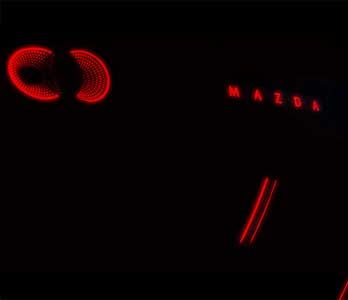 Close up of the red tail lights of an electric Mazda car