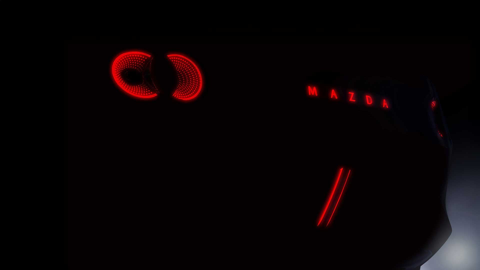 Close up of the red tail lights of an electric Mazda car