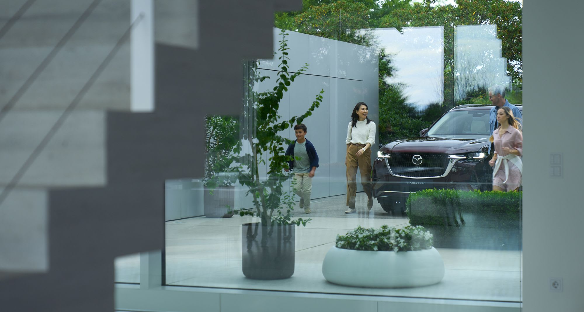 Mazda SUV on display with people walking around it