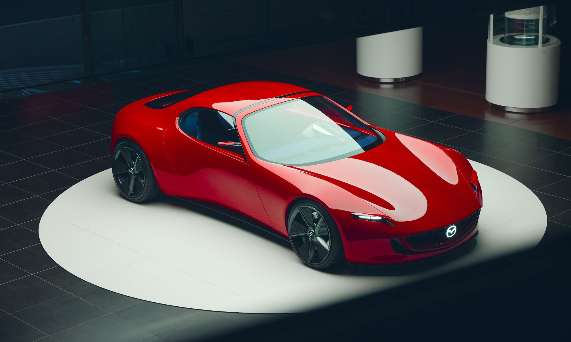 High front three quarter view of a red Mazda Iconic SP concept car on display