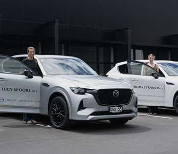Mazda ambassadors Lucy Spoors and Brooke Francis standing next to their Mazda SUVs