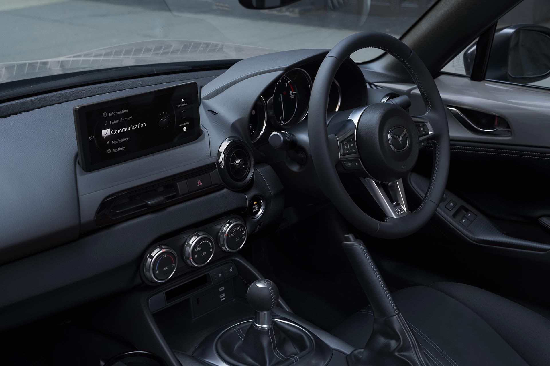 Interior of a Mazda MX-5 with a black trim