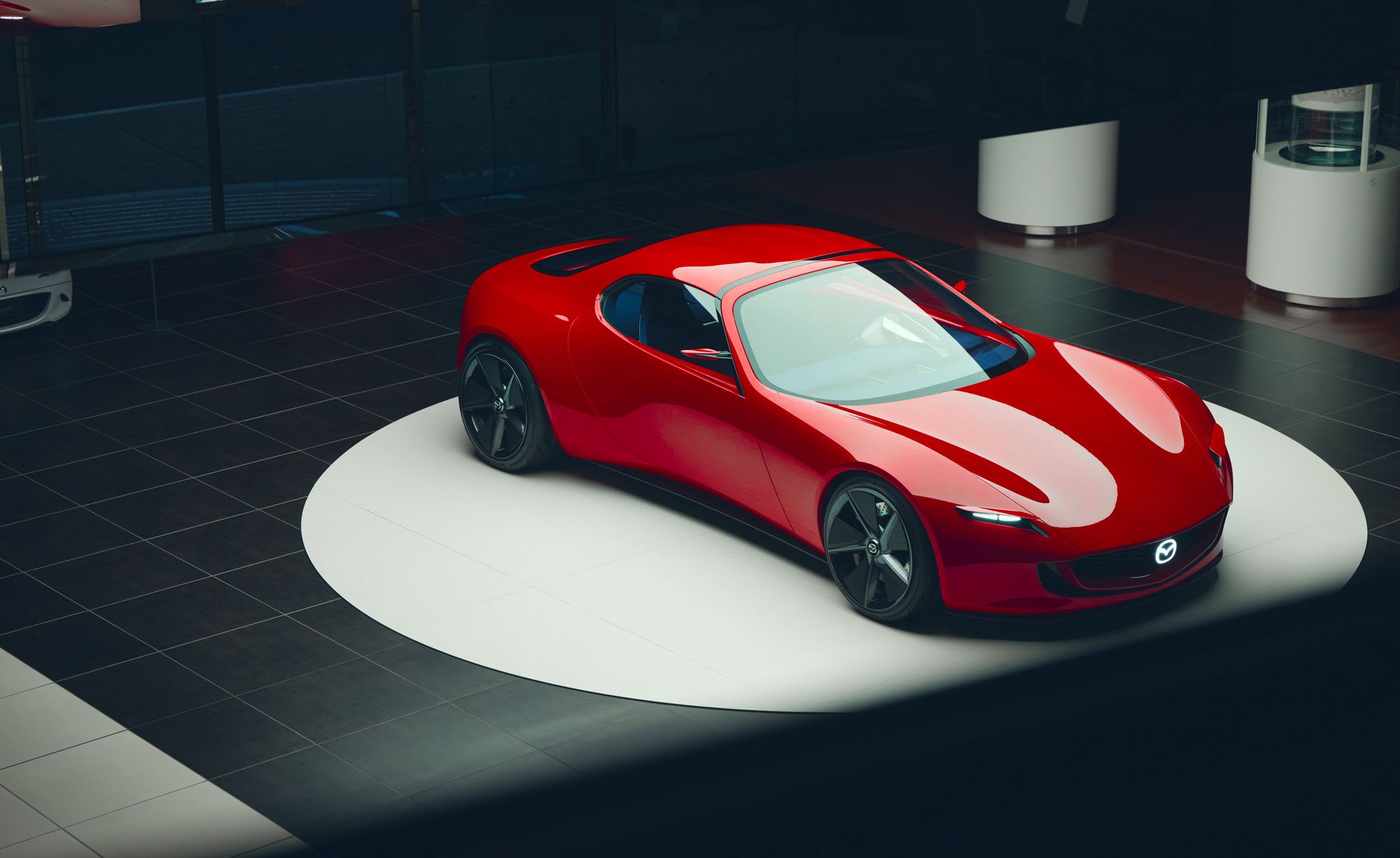 Top front three quarter view of a red Mazda Iconic SP concept car on display