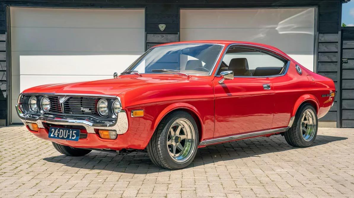 Front three quarter view of a classic red Mazda RX-4