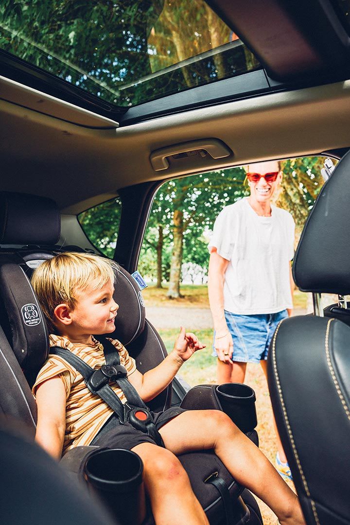 Mazda NZ rowing ambassador Brooke Francis with her son sitting inside her Mazda CX-60 SUV
