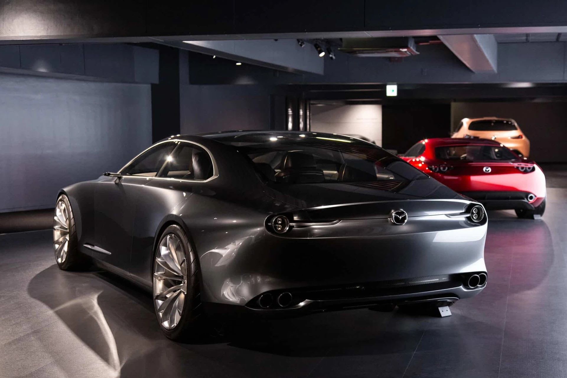 Rear three quarter view of a dark grey Mazda concept car on display at the Mazda Museum