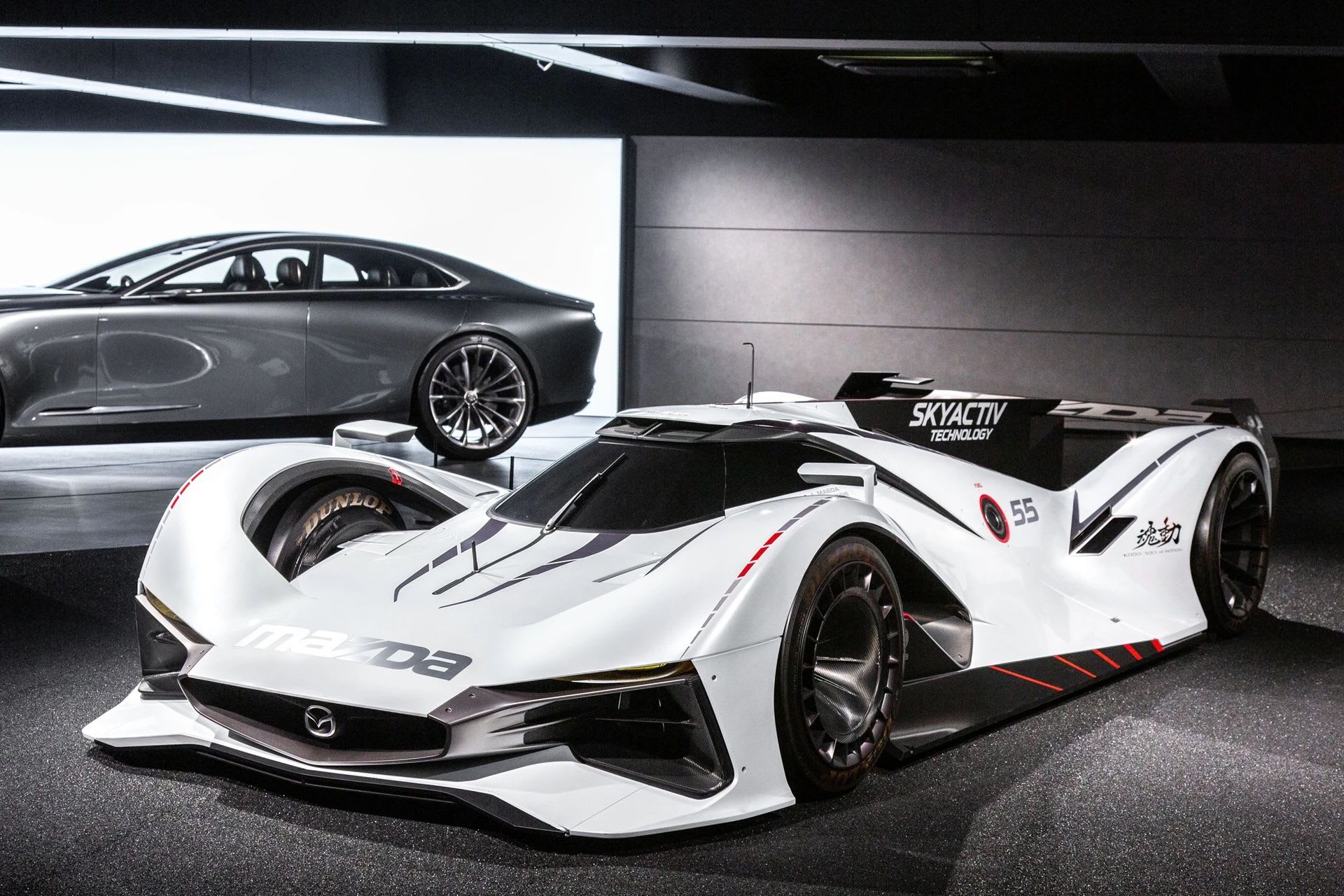 Front three quarter view of a white Mazda concept race car on display at the Mazda Museum