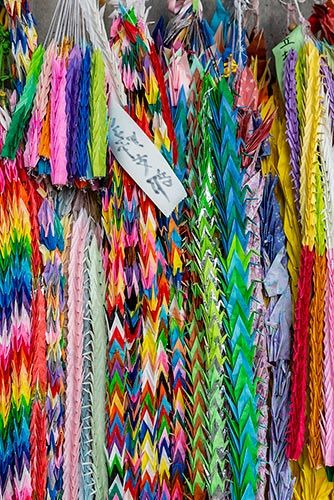 Donated origami paper cranes from all over the worldhanging outside the Children’s Peace Monument in Hiroshima, Japan