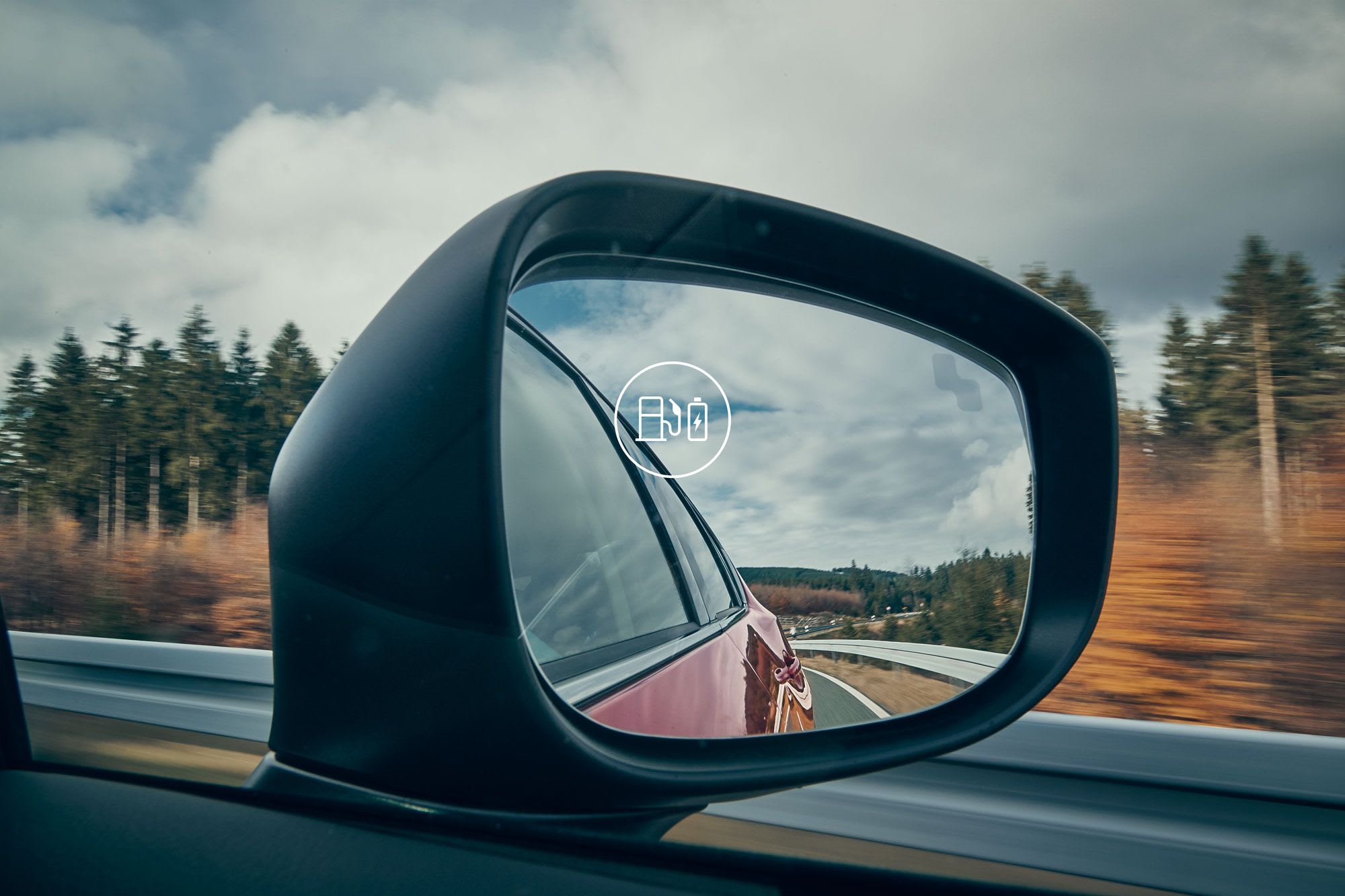 View of the driver's wing mirror as viewed from the driver's seat of a Mazda car