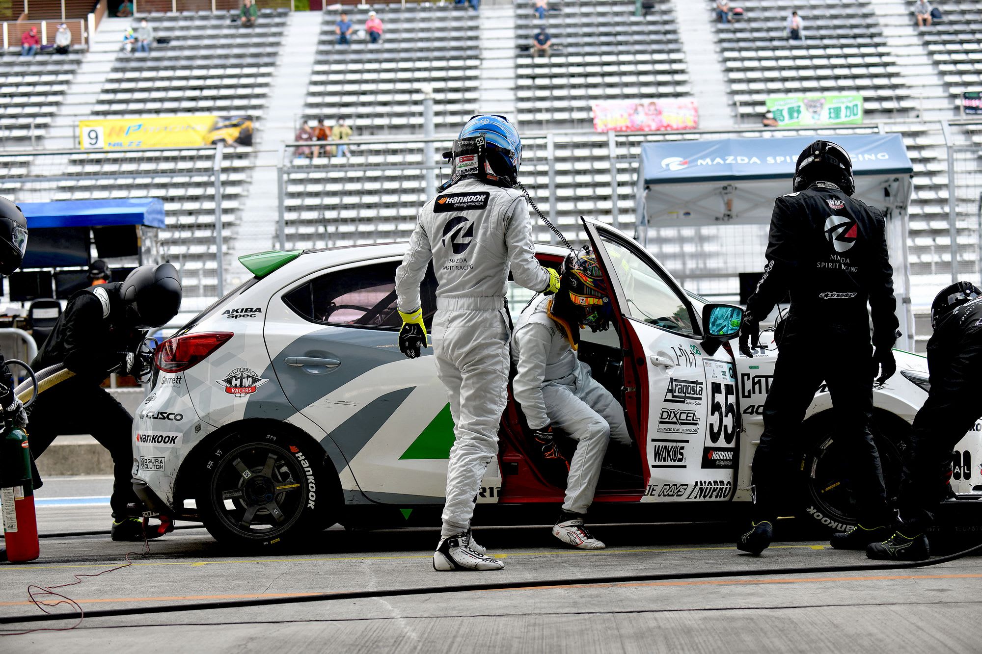 Side view of a Mazda2 Bio concept in the pits at a race track during a driver change