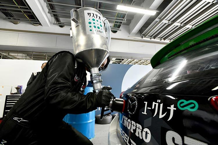 Pit mechanic filling the Mazda2 Bio concept race car with biodiesel fuel 