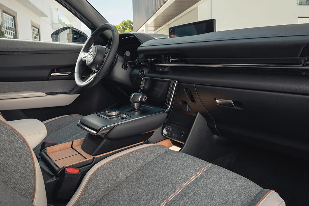 Interior view of a Mazda car showing the grey cloth seats and black dashboard