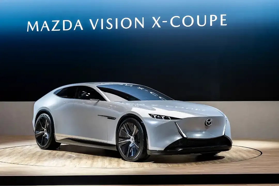 Front three quarter view of a white Mazda Vision X-Coupe concept car on the stand at the Japan Mobility Show 2025