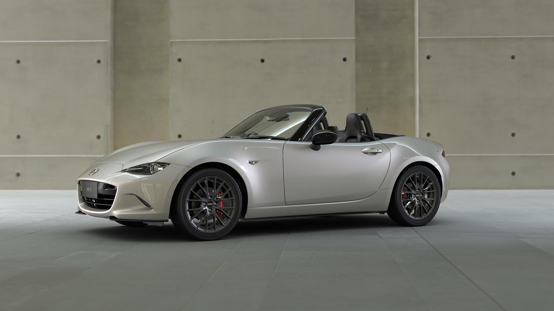 Front three quarter view of a Platinum Quartz Mazda MX-5 in a gallery