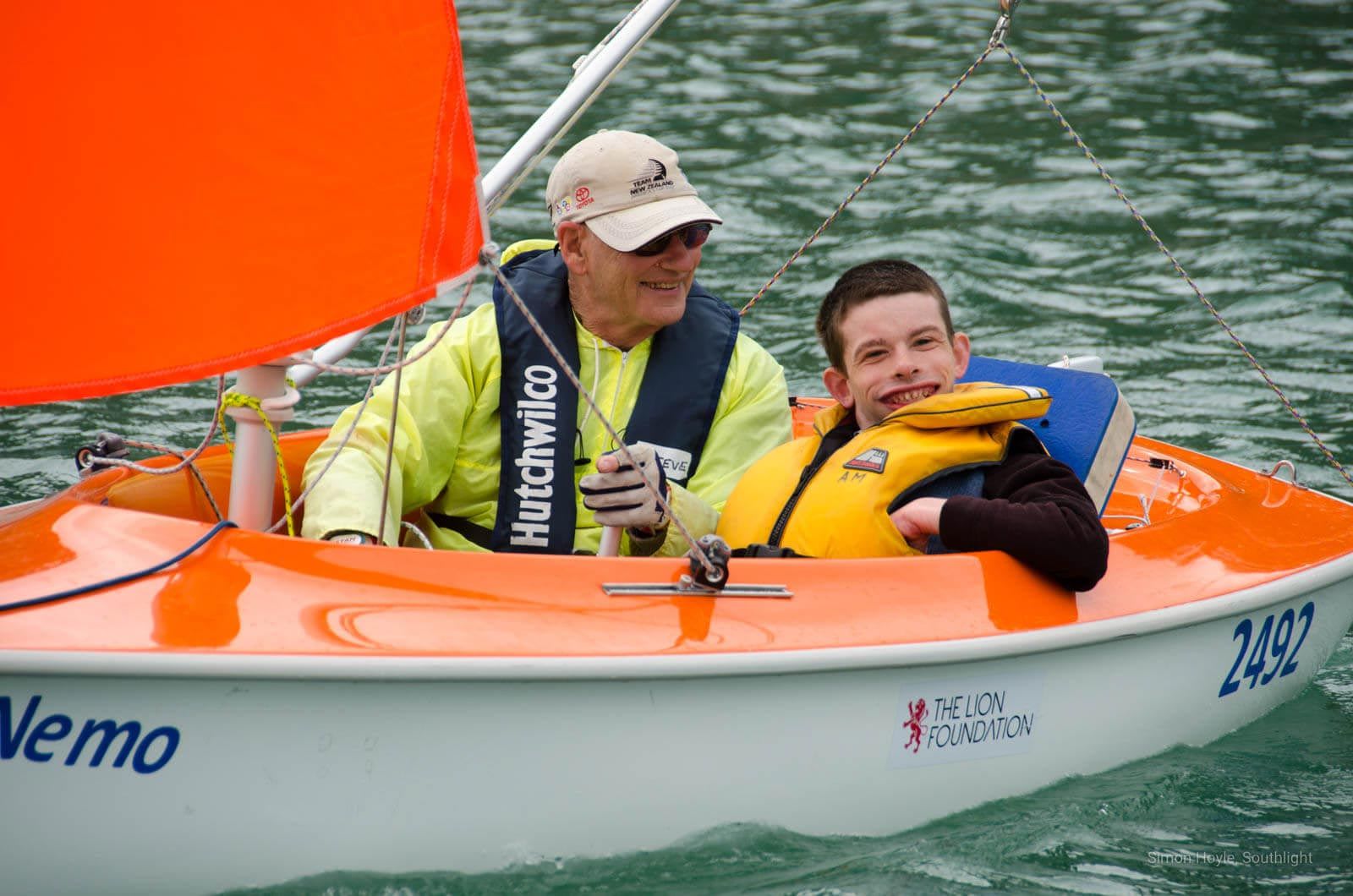 Man and boy on a small sail boat