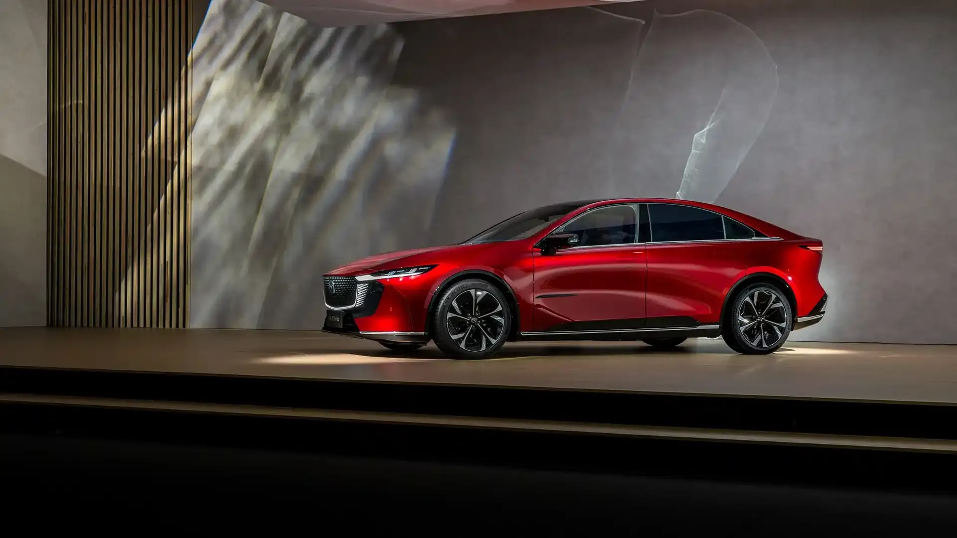 Side view of a fully electric red Mazda 6e on display