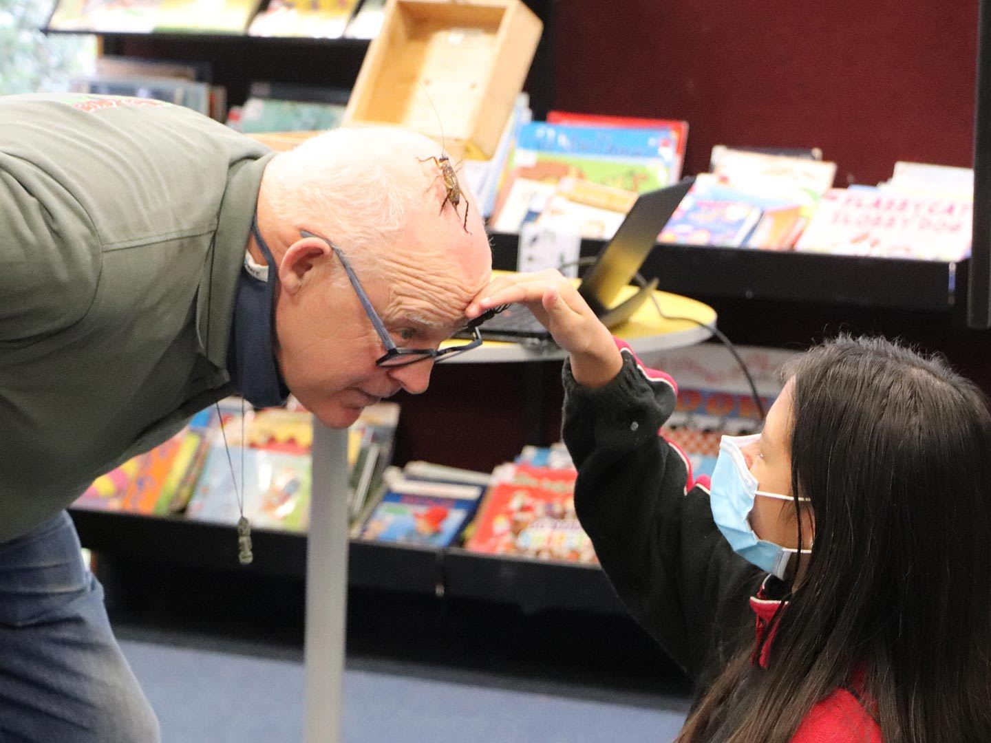 Ruud “the Bugman” Kleinpaste, with a Rhode Street School student, pictured with a bug on his head