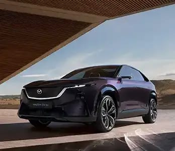 Front three quarter view of a purple Mazda CX-6e electric SUV