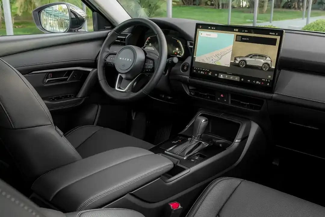 Interior view of the front black leather seats, steering wheel and large centre touchscreen of the all-new Mazda CX-5 SUV 