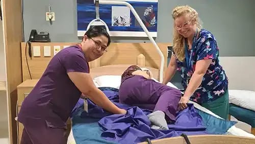 Nurses and patient in a room at Totara Hospice