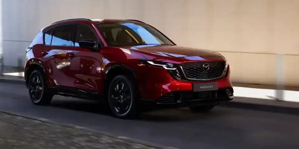 Front three quarter view of a Soul Rec Mazda CX-5 SUV driving along a street