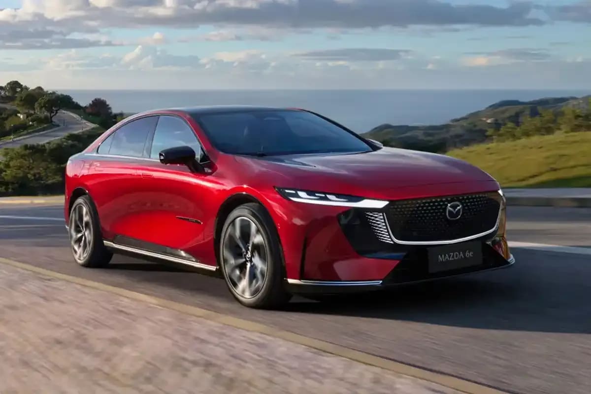 Front three quarter Soul Red all-electric Mazda 6e hatchback with impressive electric power