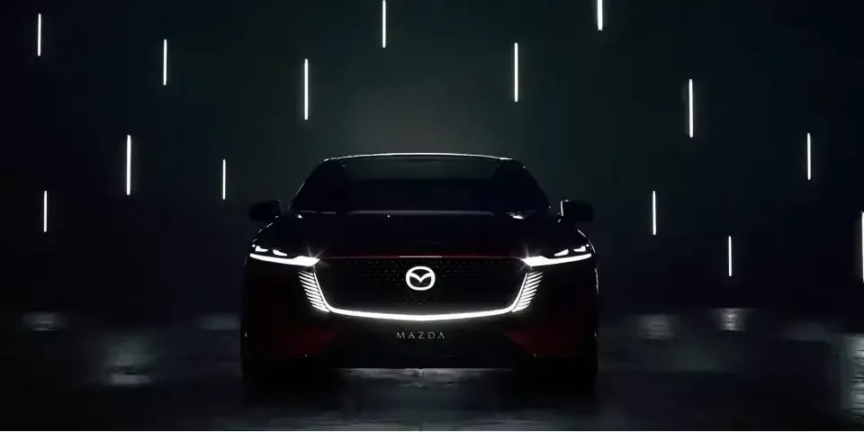 Front silhouette view of the all-electric Mazda 6e showing the signature light design 
