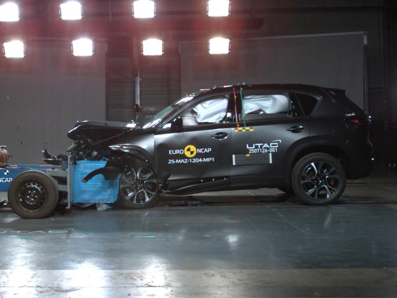 Side view of a dark grey Mazda CX-5 undergoing a crash test for an ANCAP five-star safety rating