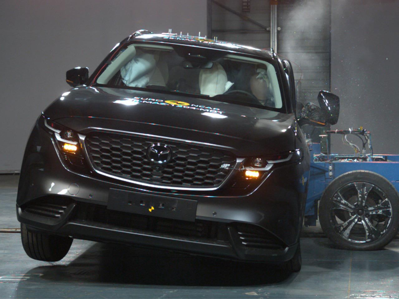 Front view of a dark grey Mazda CX-5 undergoing a crash test for an ANCAP five-star safety rating