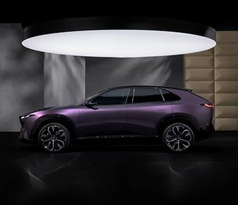 Side view of a Nightfall Violet all-electric Mazda CX-6e SUV on display