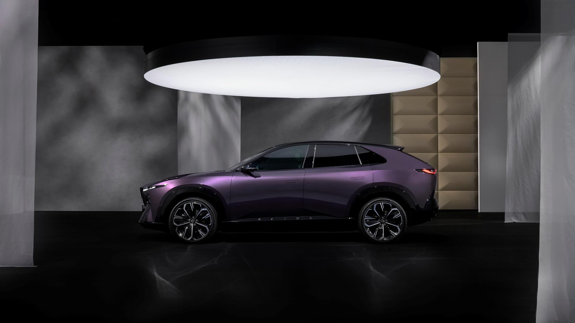 Side view of a Nightfall Violet all-electric Mazda CX-6e SUV on display